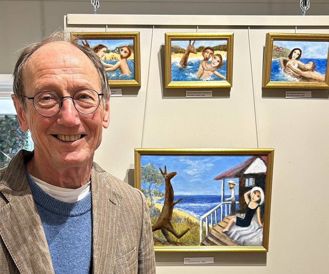 Man in front of paintings