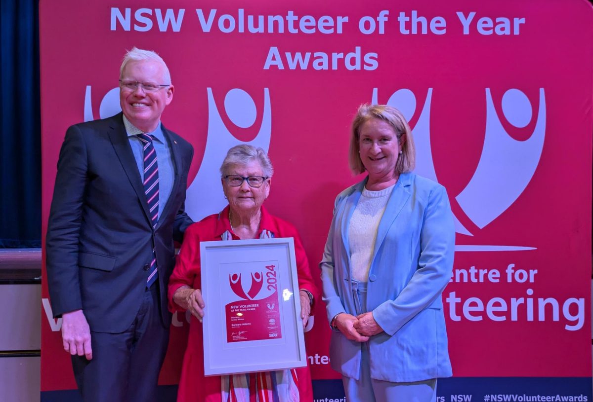 three people at award ceremony