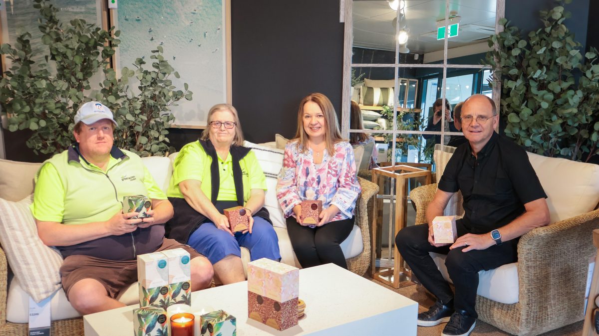 Four people sitting on a lounge