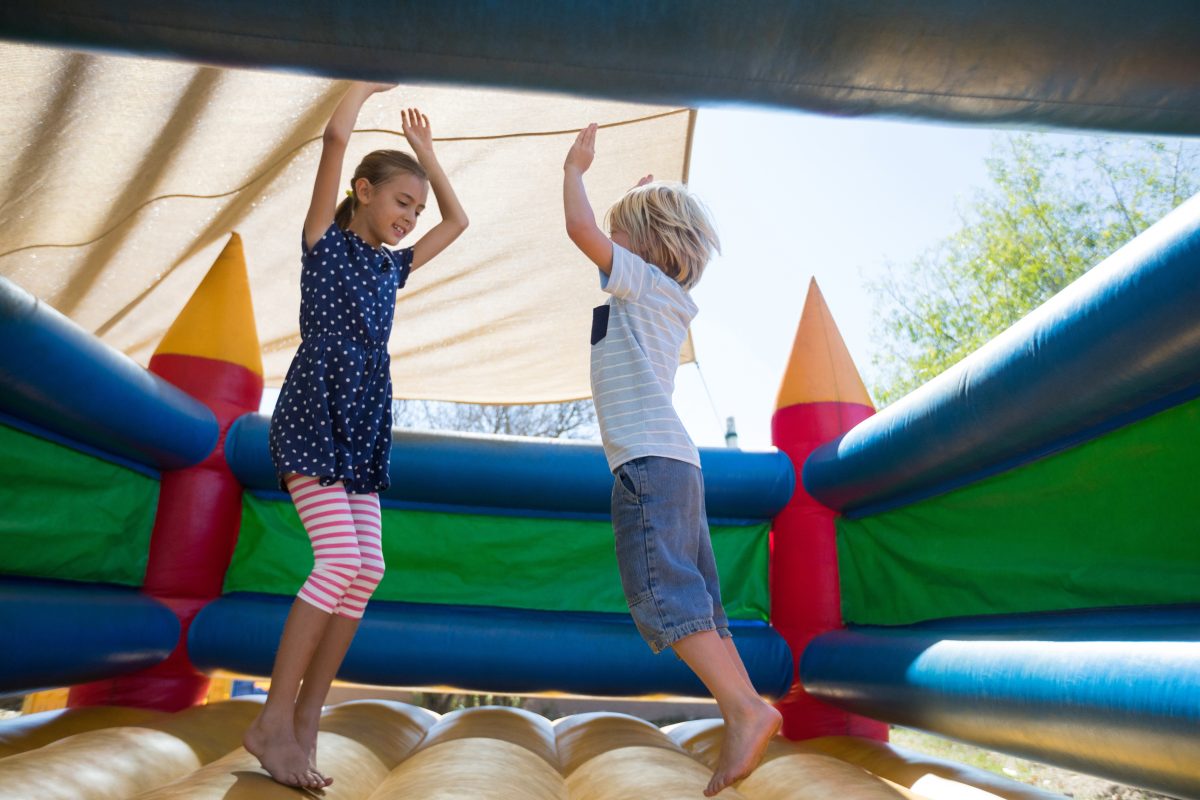 Kids jumping in a jumping castle