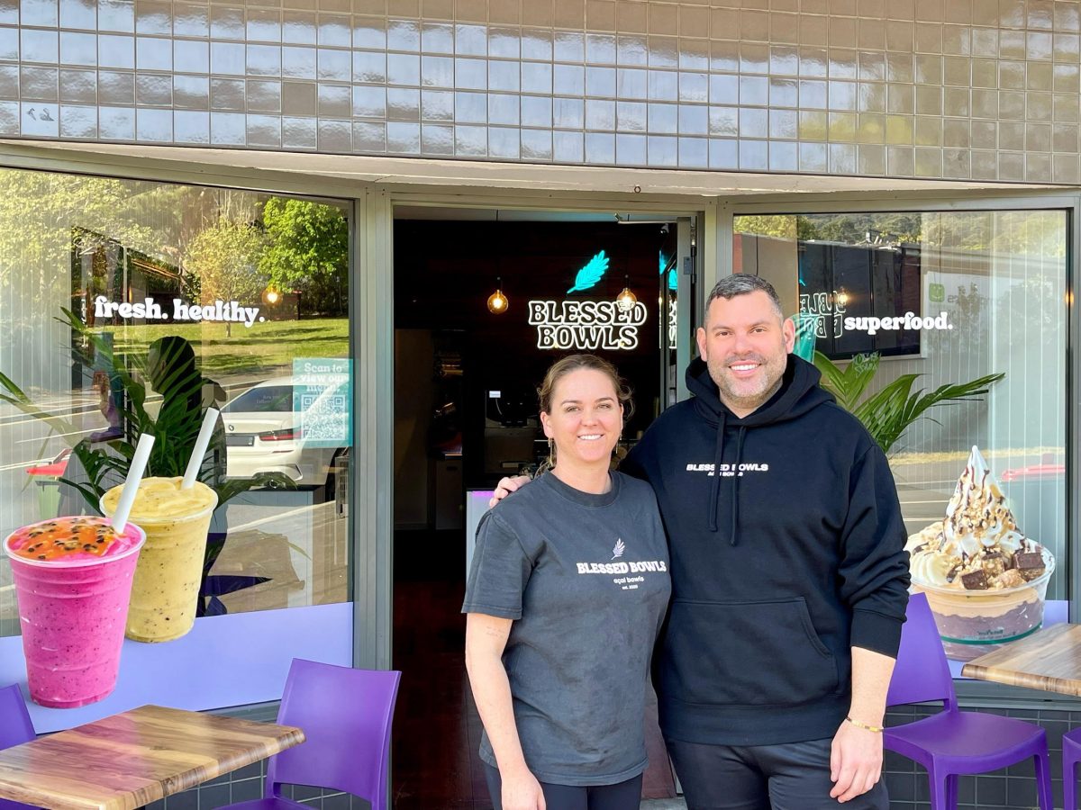 Blessed Bowls Thirroul owners Saskia Martin and Adrian Erdedi stand outside their shop and smile