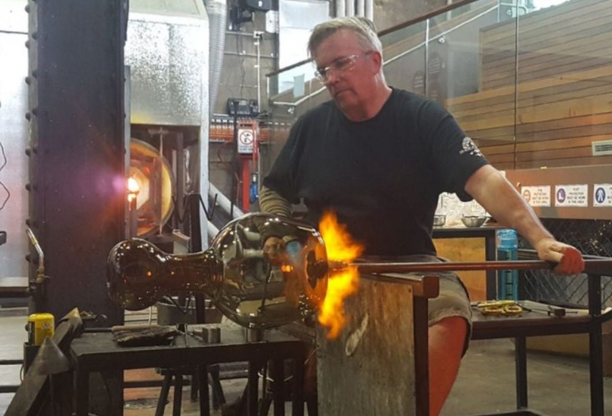 man creating glass art