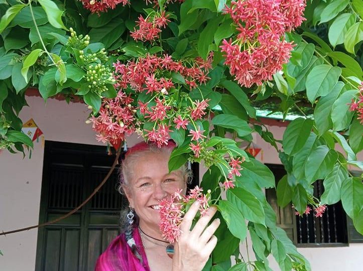 woman standing behind plant