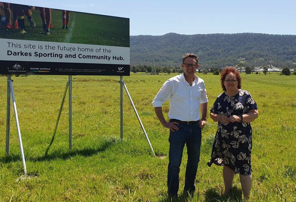 Stephen Jones stands in a field with Wollongong City Council Lord Mayor Tania Brown