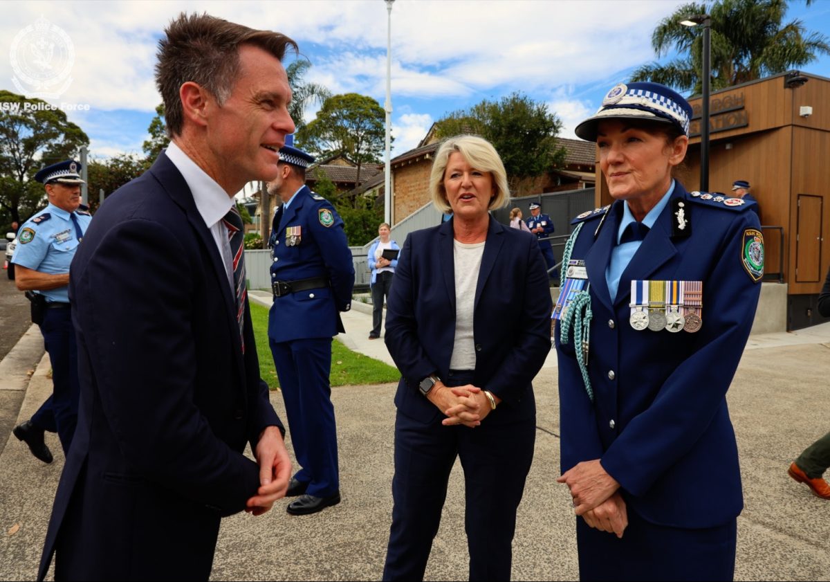 man, woman and police chief at official opening of police station