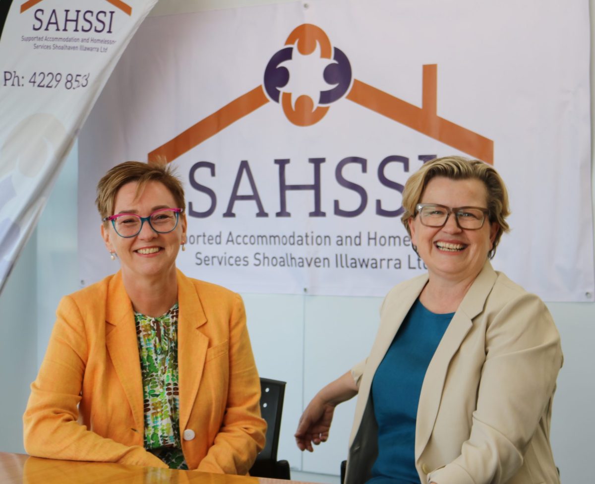 TWO women in front of SAHSSI sign.