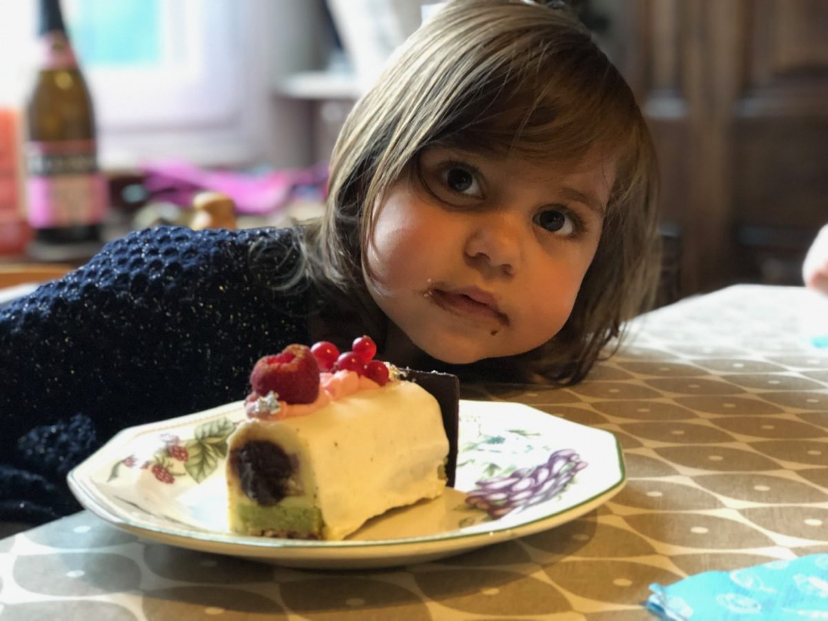 A small child enjoys a cake