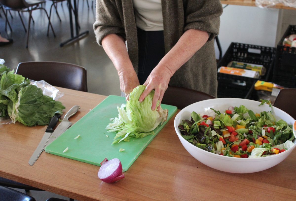 a woman preparing food in a community group kitchen