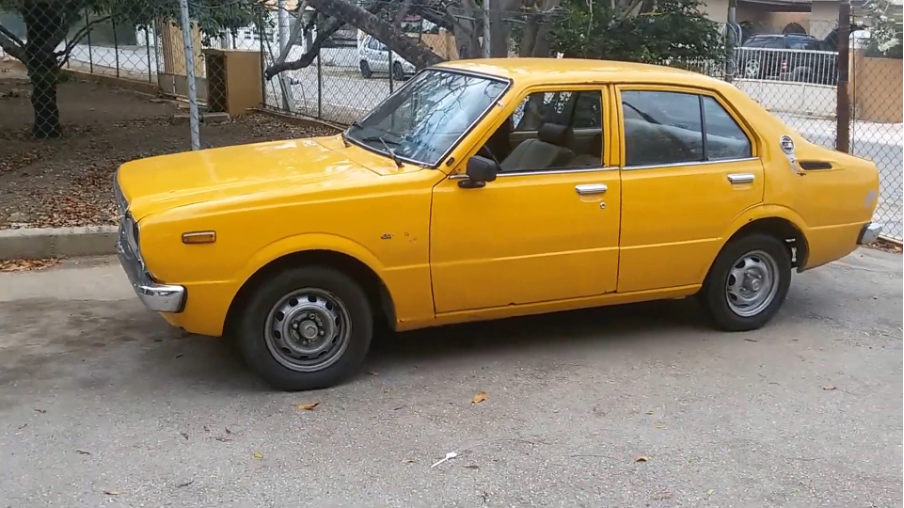 Mustard coloured retro Toyota Corolla