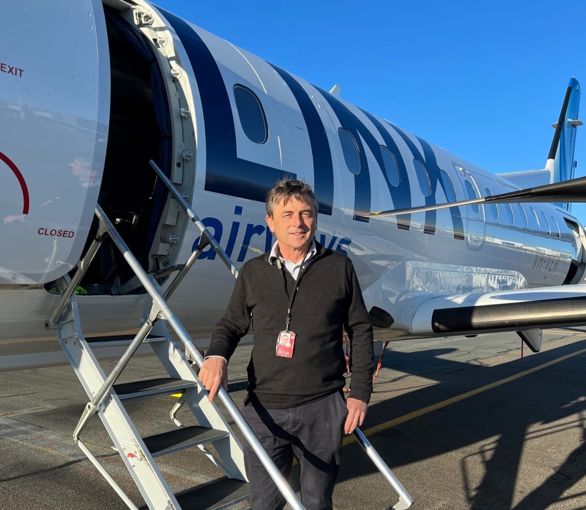 Man on steps of plane