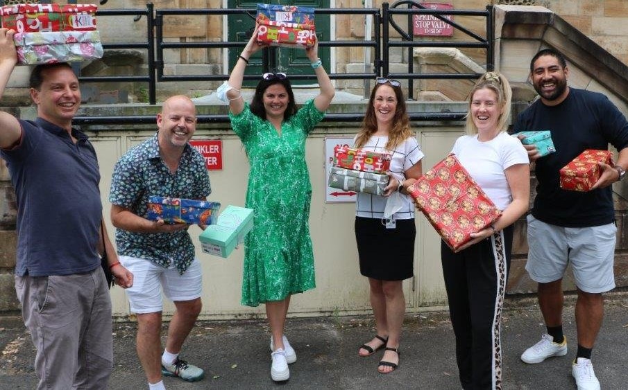 Group of people holding Christmas presents