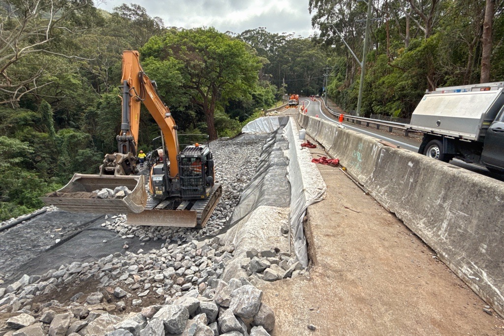 Excavator working beside a road