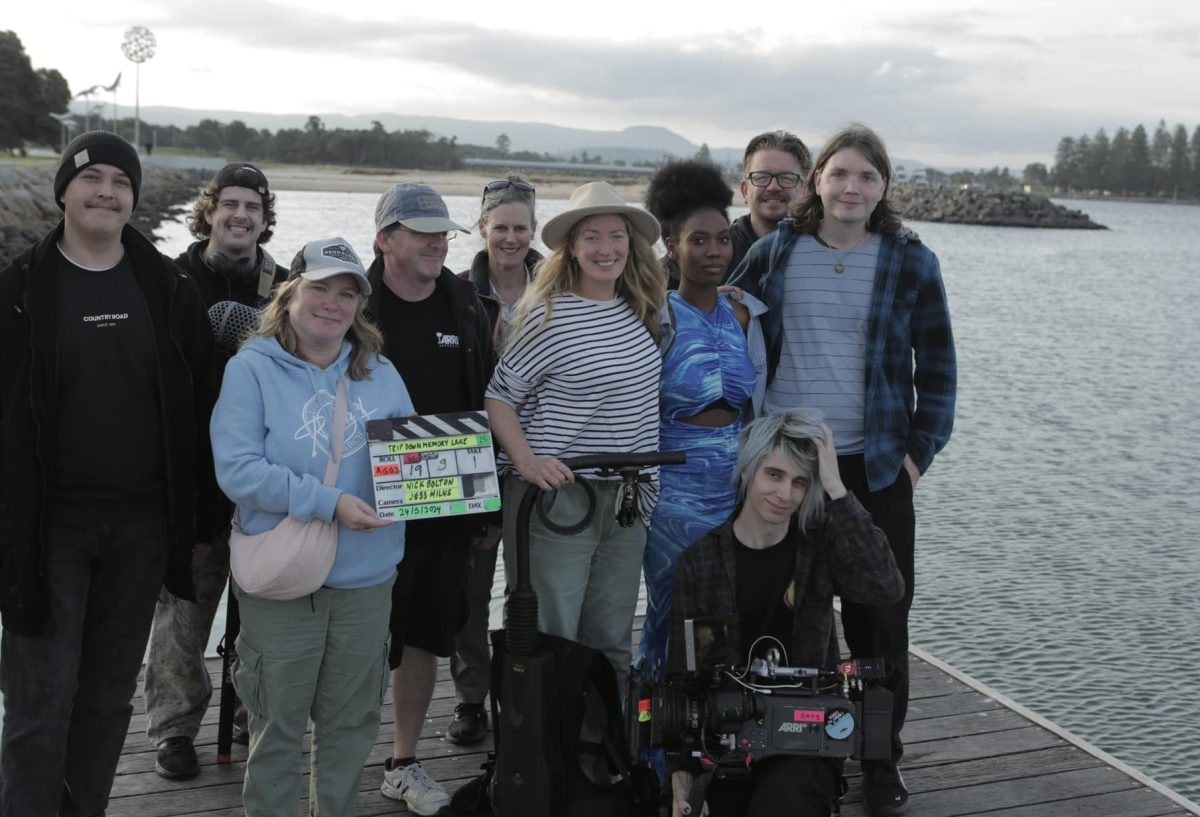 A movie crew by a lake