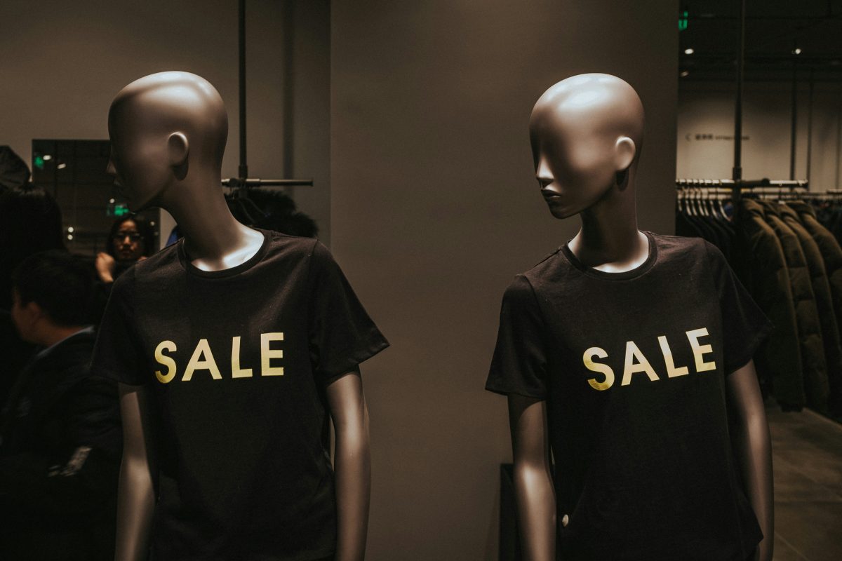 Mannequins in black 'sale' shirts.