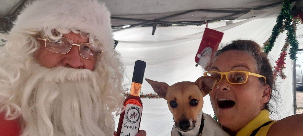 Santa holds a bottle of honey mead at Berry Village Market