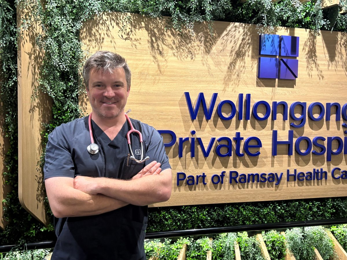 Cardiac Nurse David Sewell outside Wollongong Private Hospital sign.