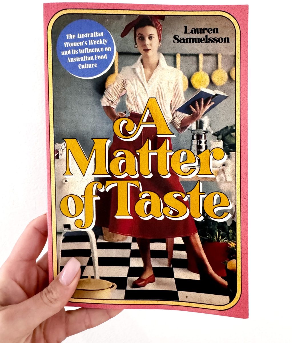 The cover of A Matter of Taste featuring a retro-looking housewife in a kitchen.