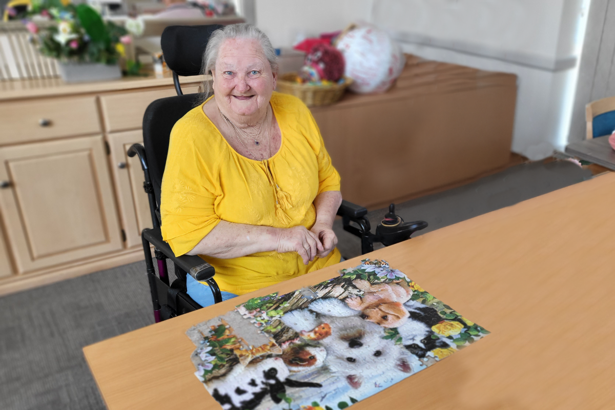 IRT resident doing a puzzle in aged care facility.