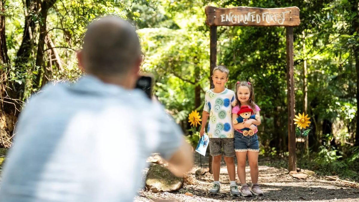 Dad takes photos of his kids at the Illawarra Fly Paddington Bear activity