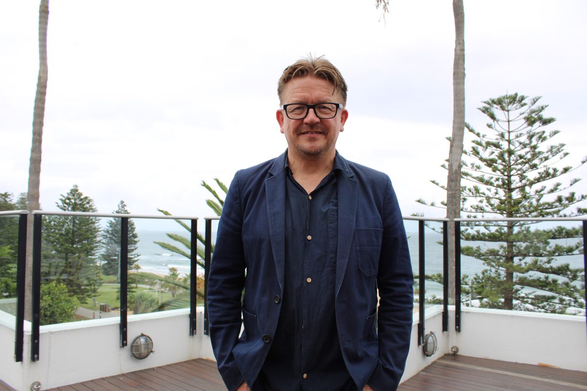 A man standing at a foreshore venue deck