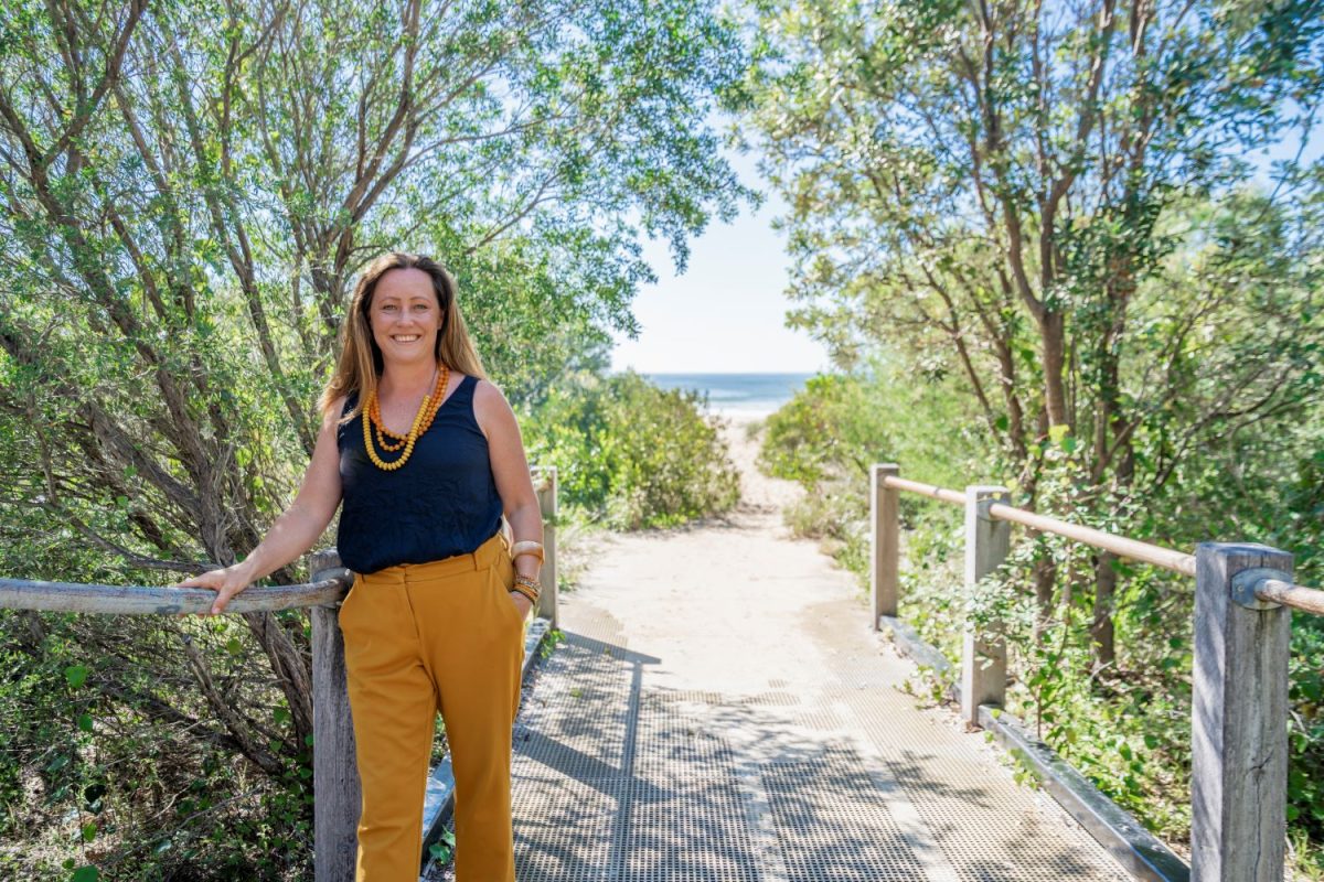 Woman stand on path to beach