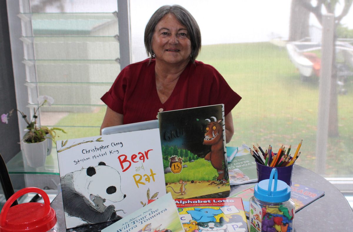 woman with school picture books and pencils