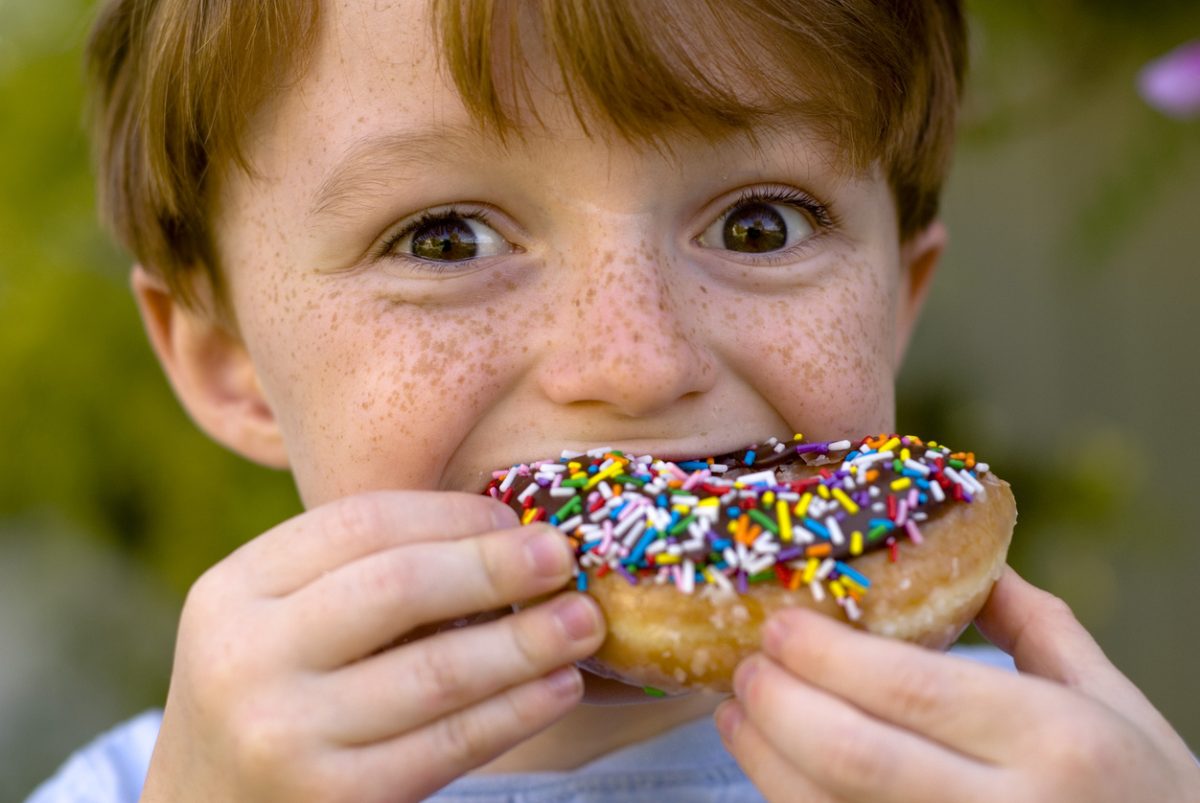 A child eating a chocolate donut