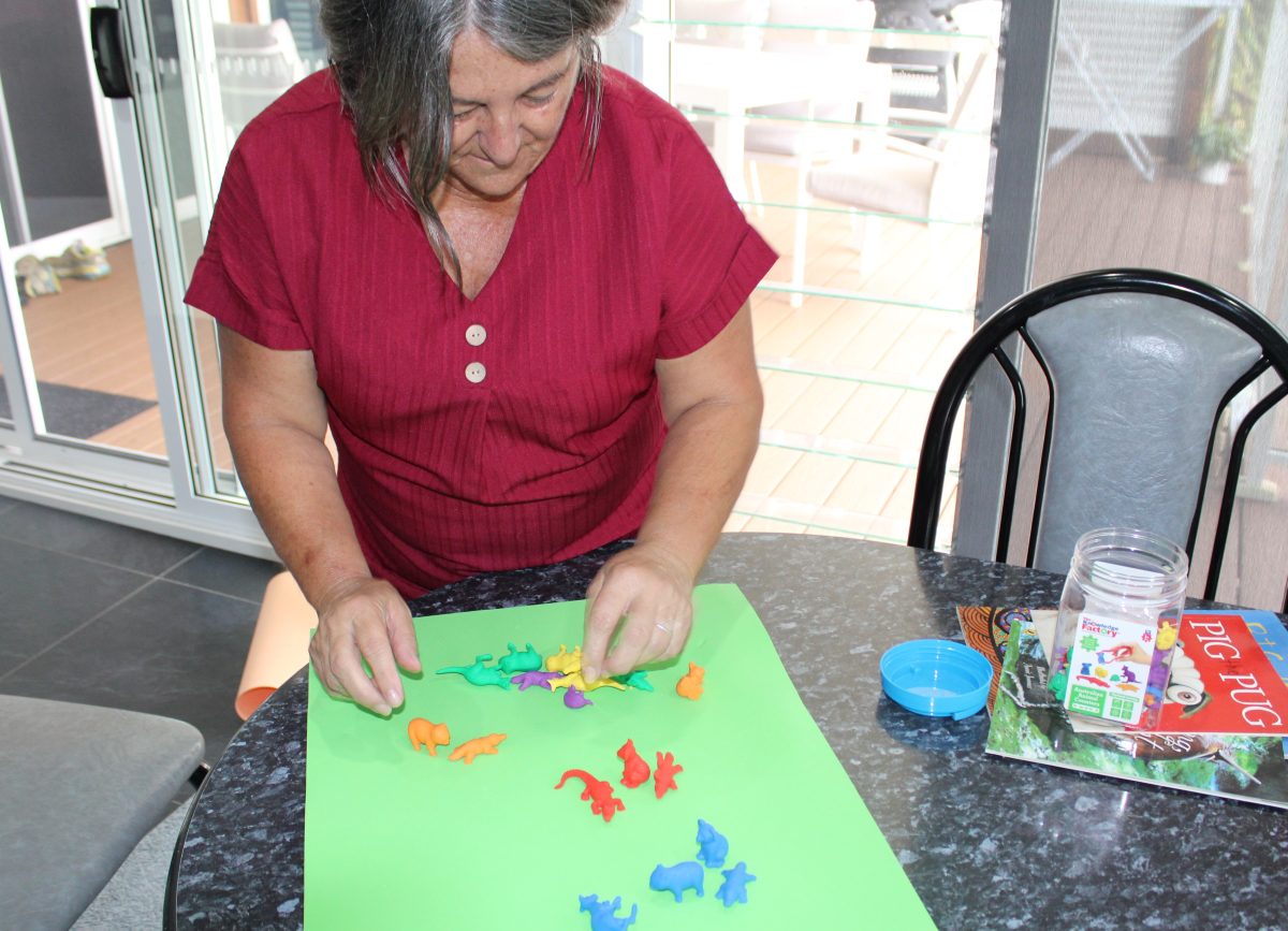 Woman sorting toys into different colours