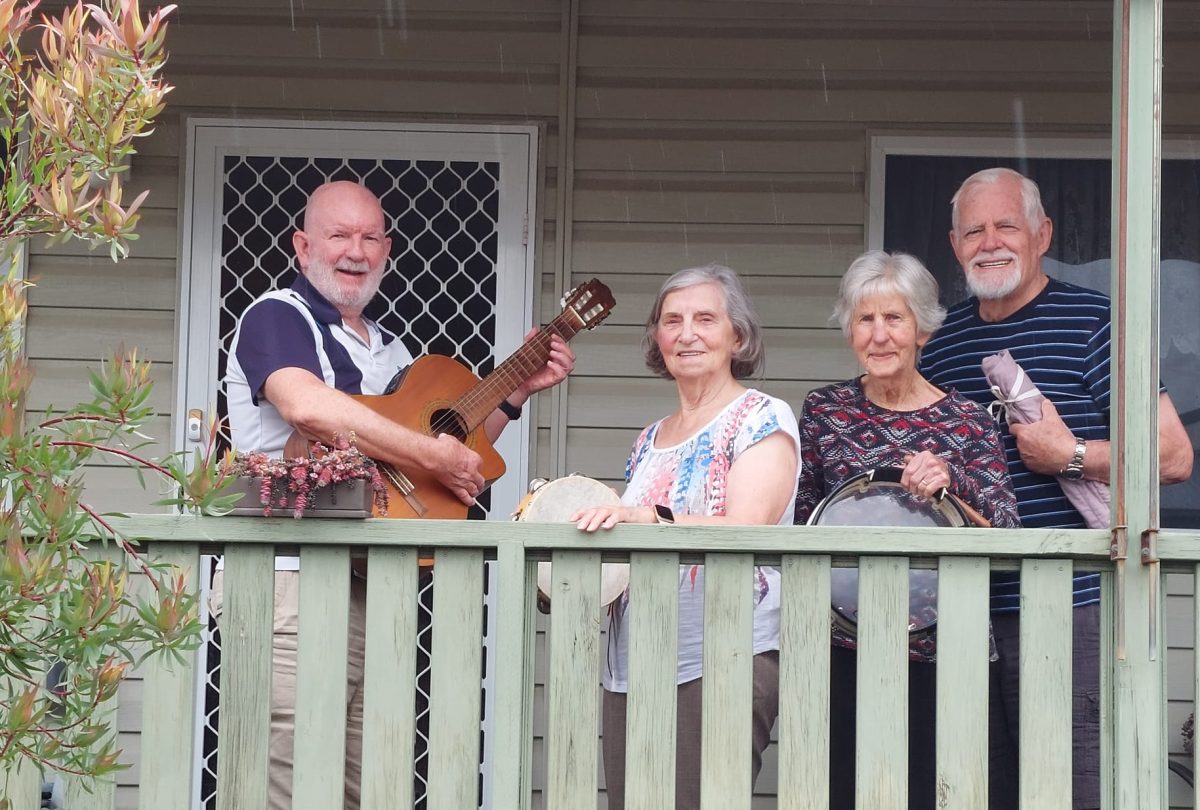 Four band members from Chord-eaux on a balcony