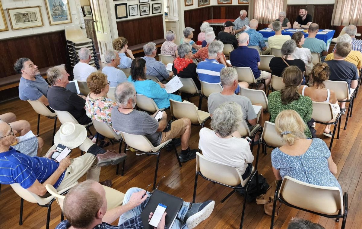 People sitting in a town hall-style meeting