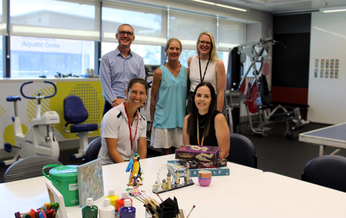 A group of people in an office with therapy equipment