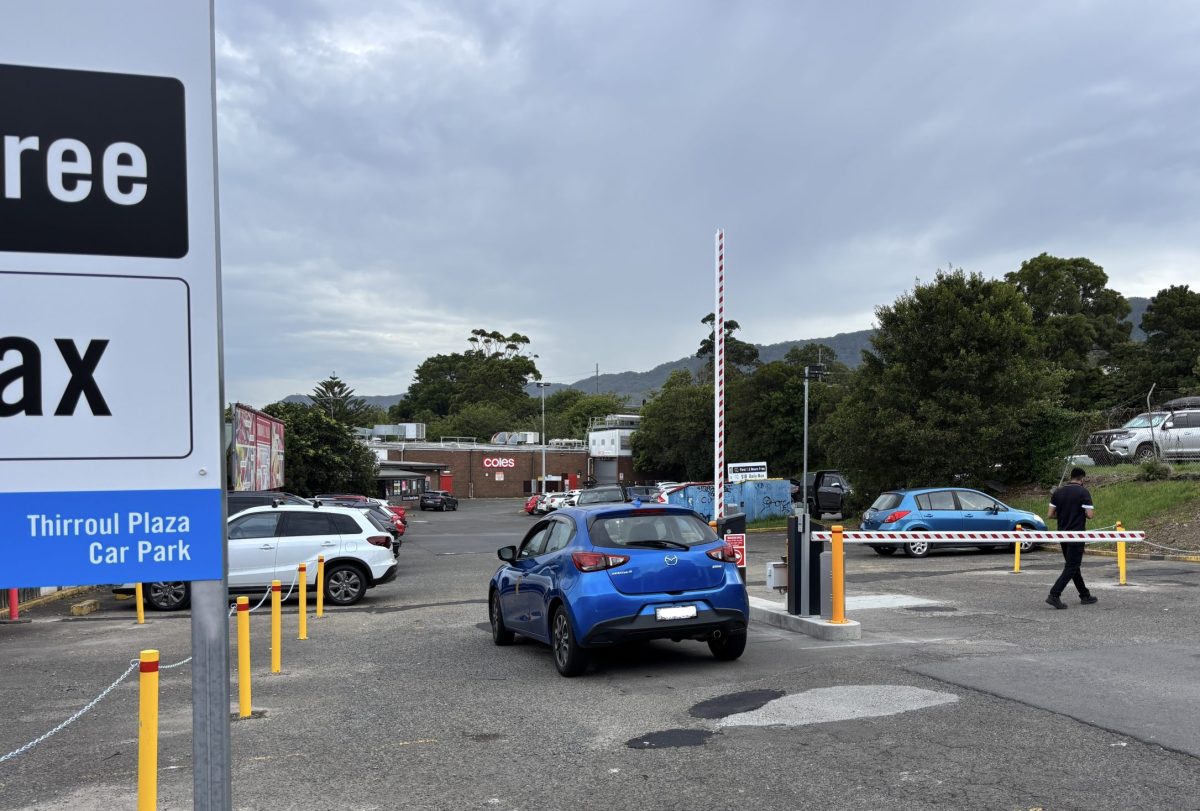 Car enters Thirroul Plaza Coles car park through boom gates