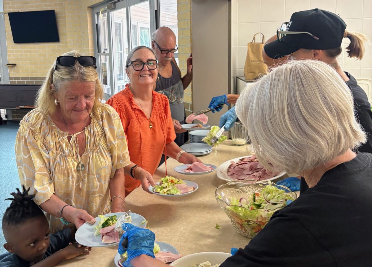 People line up to be served lunch by Need a Feed volunteers