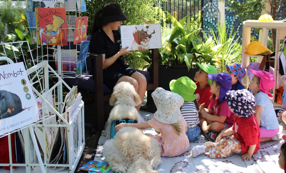 St Luke's Preschool Kids read with Harvey the therapy dog.