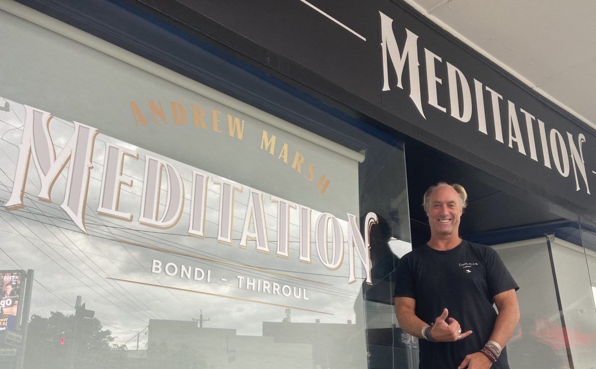 Andrew Marsh smiles in front of his Thirroul meditation studio