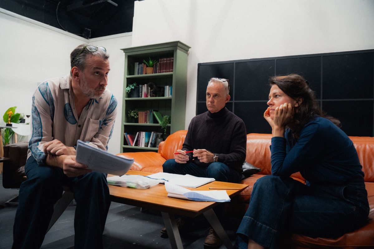 three people in conversation in an office