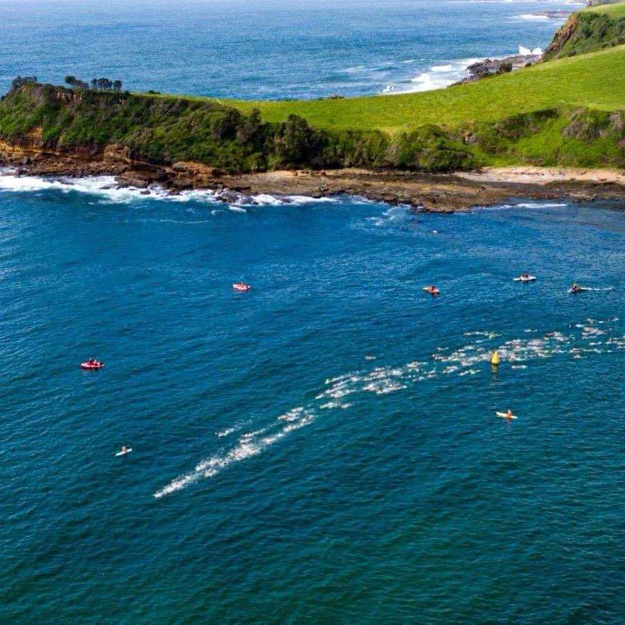 Swimmers cut a path through the ocean off Gerringong for the annual Captain Christie Ocean Swim.