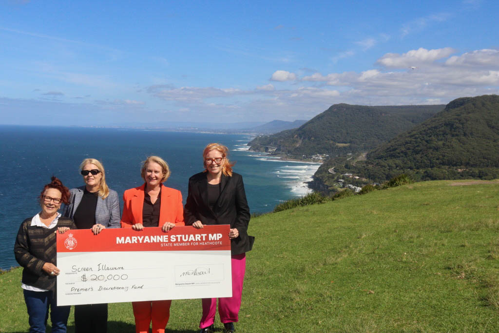 four women holding a large cheque