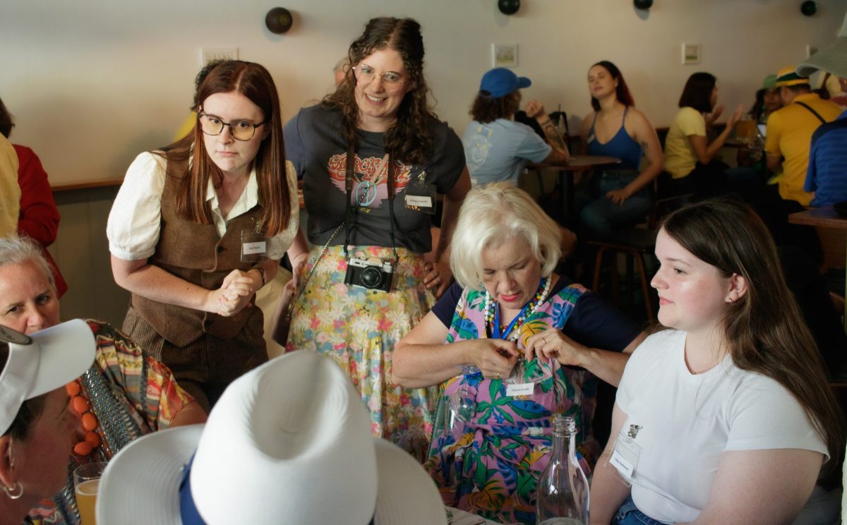 people mingle at an event with theatre actors