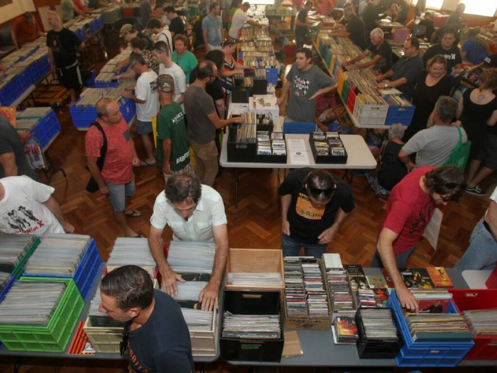 People dig through crates of records