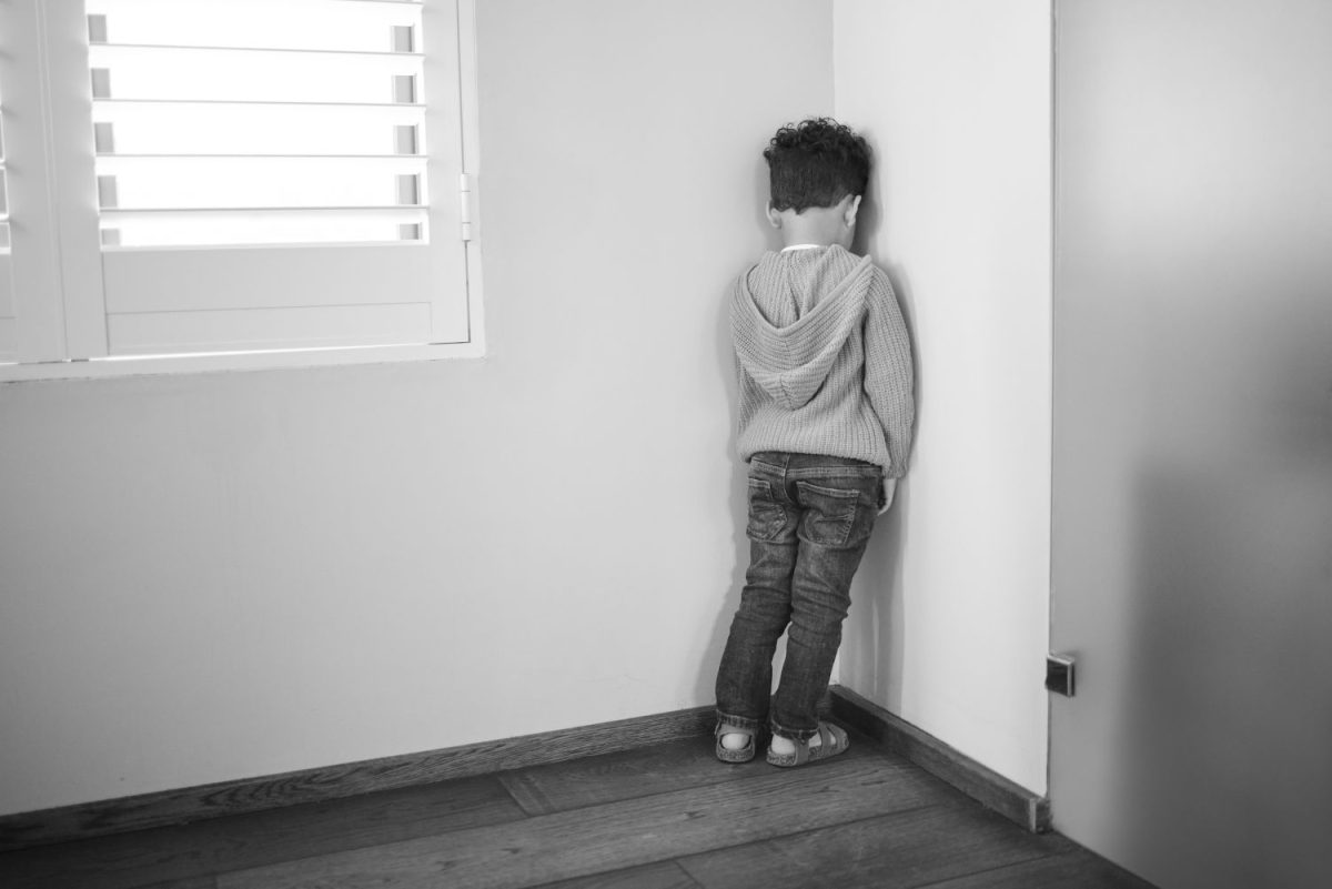 Boy standing in corner
