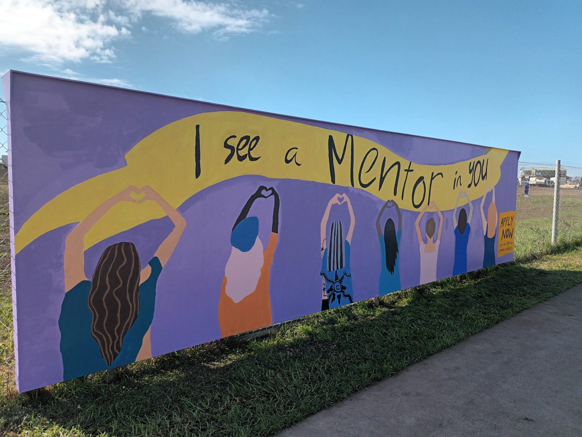 People paint a mural that says I See A Mentor In You