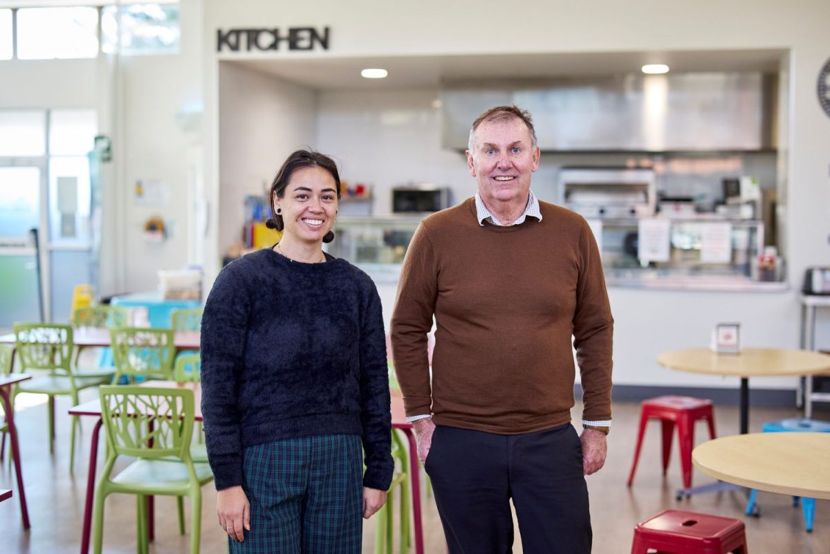 Two people in cafe/kitchen.