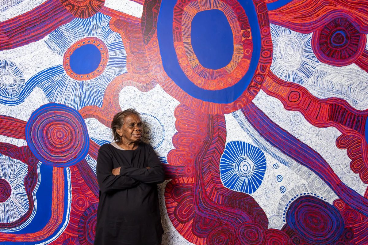 Betty Kuntiwa Pumani of Mimili Maku stands with her painting