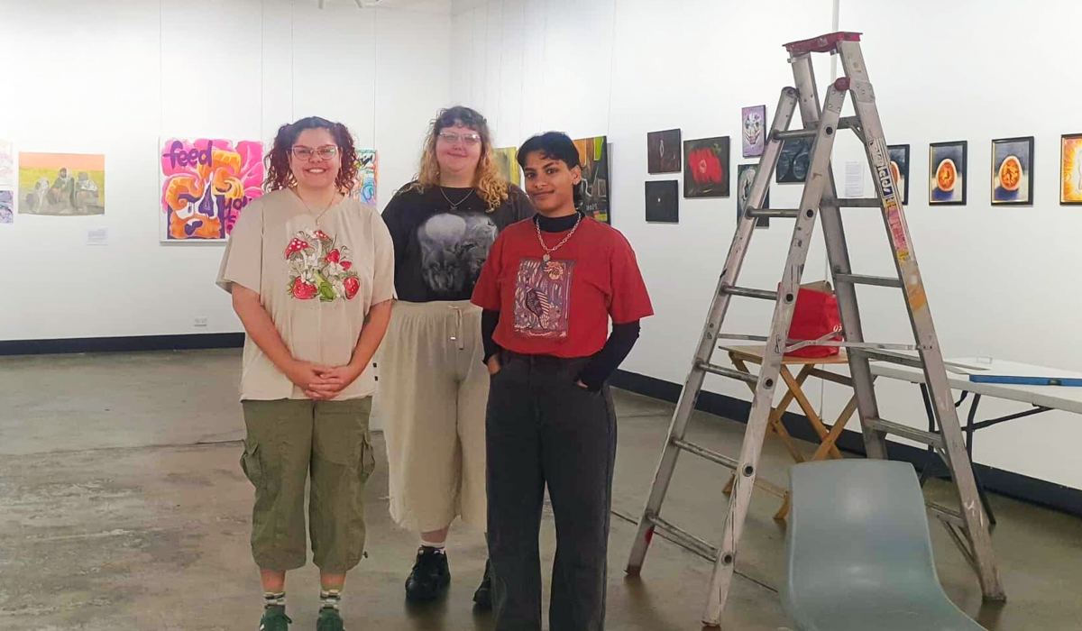 Artist Meissa Mason with curators Eren Maltby and Monisha Kumar set up Project Contemporary Artspace in Wollongong for the annual Pride month exhibition.