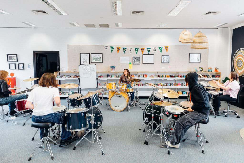 Students at a Girls Rock! camp in Adeliade hone their skills on the drums. Wollongong will host a You Rock! camp for girls, trans, and non-binary teens this year.