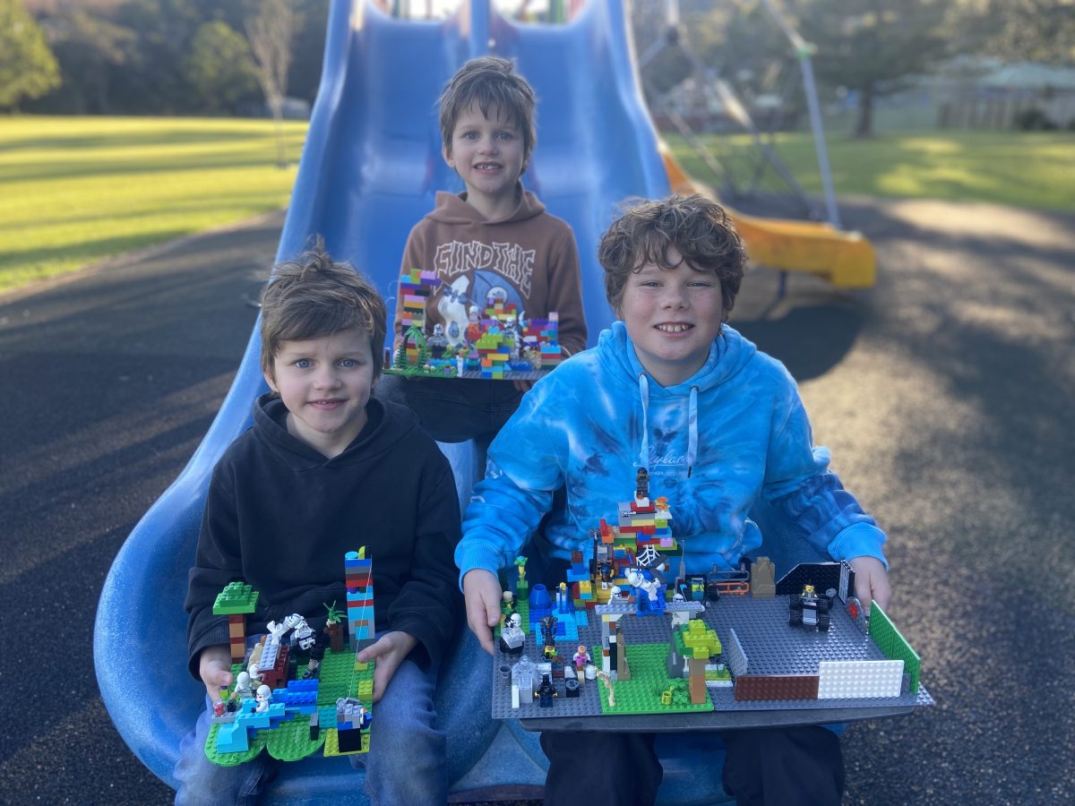 Three boys at a playground with LEGO