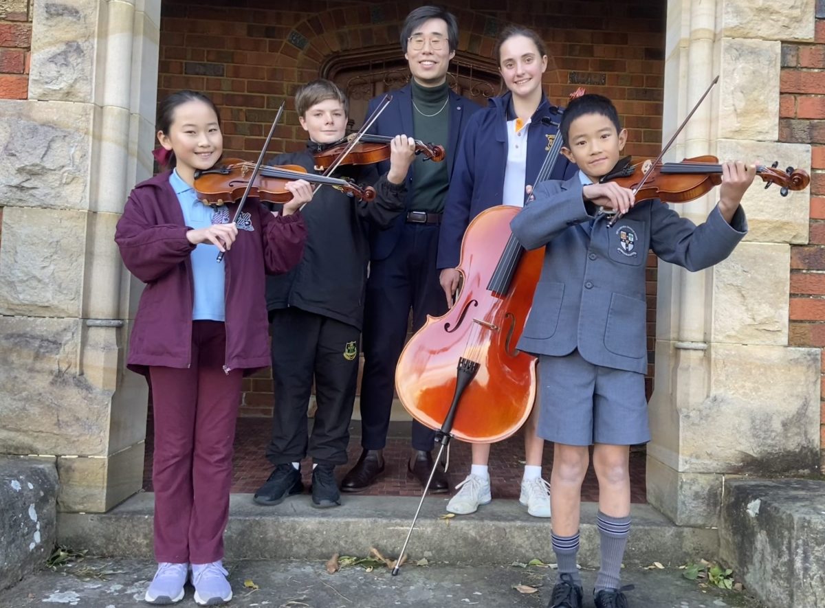 Wollongong Conservatorium Junior String Quartet with their instruments and teacher Jack Mao