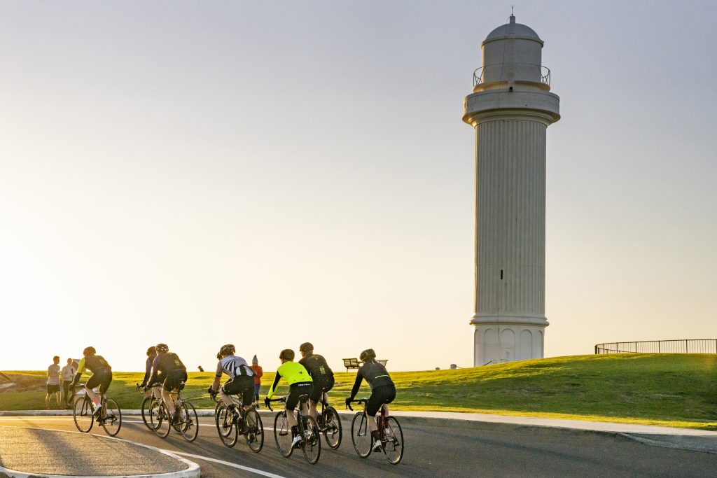 Cyclists in front of lighthouse