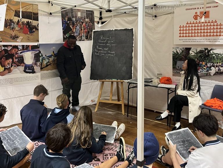 man speaking to a class of high school students